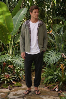 green hoodie jacket by the sea