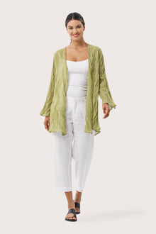 Woman wearing the Ravenna Cotton Outerwear Lime Green designed for effortless resortwear and tropical living by By The Sea Bali