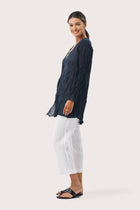 Side profile of the Ravenna Cotton Outerwear Blue showing its cut and natural movement
