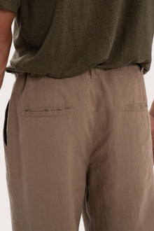 Detailed back view highlighting the relaxed silhouette and linen craftsmanship