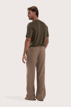 Back view of the cream linen pants with a relaxed and elegant silhouette