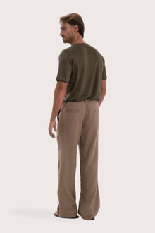 Back view of the cream linen pants with a relaxed and elegant silhouette