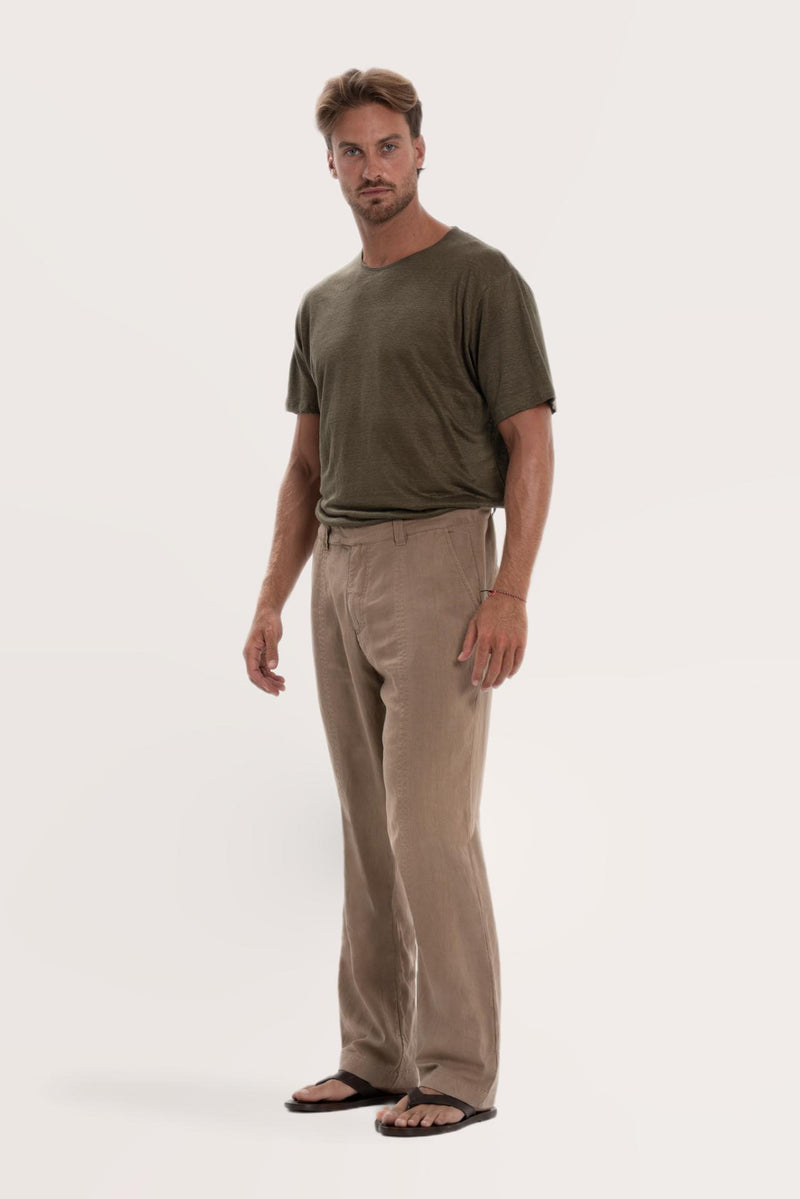 Side profile of the cream linen Rosca pants showcasing their effortless drape
