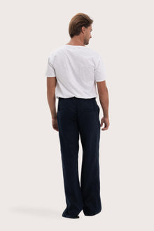 Back view of the navy linen pants with a relaxed and elegant silhouette