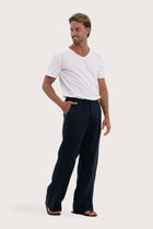 Side profile of the navy linen Rosca pants showcasing their effortless drape