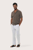 Side profile of the Salur Shirt Double Stripe in Brown highlighting its easy, breathable fit by By The Sea Bali