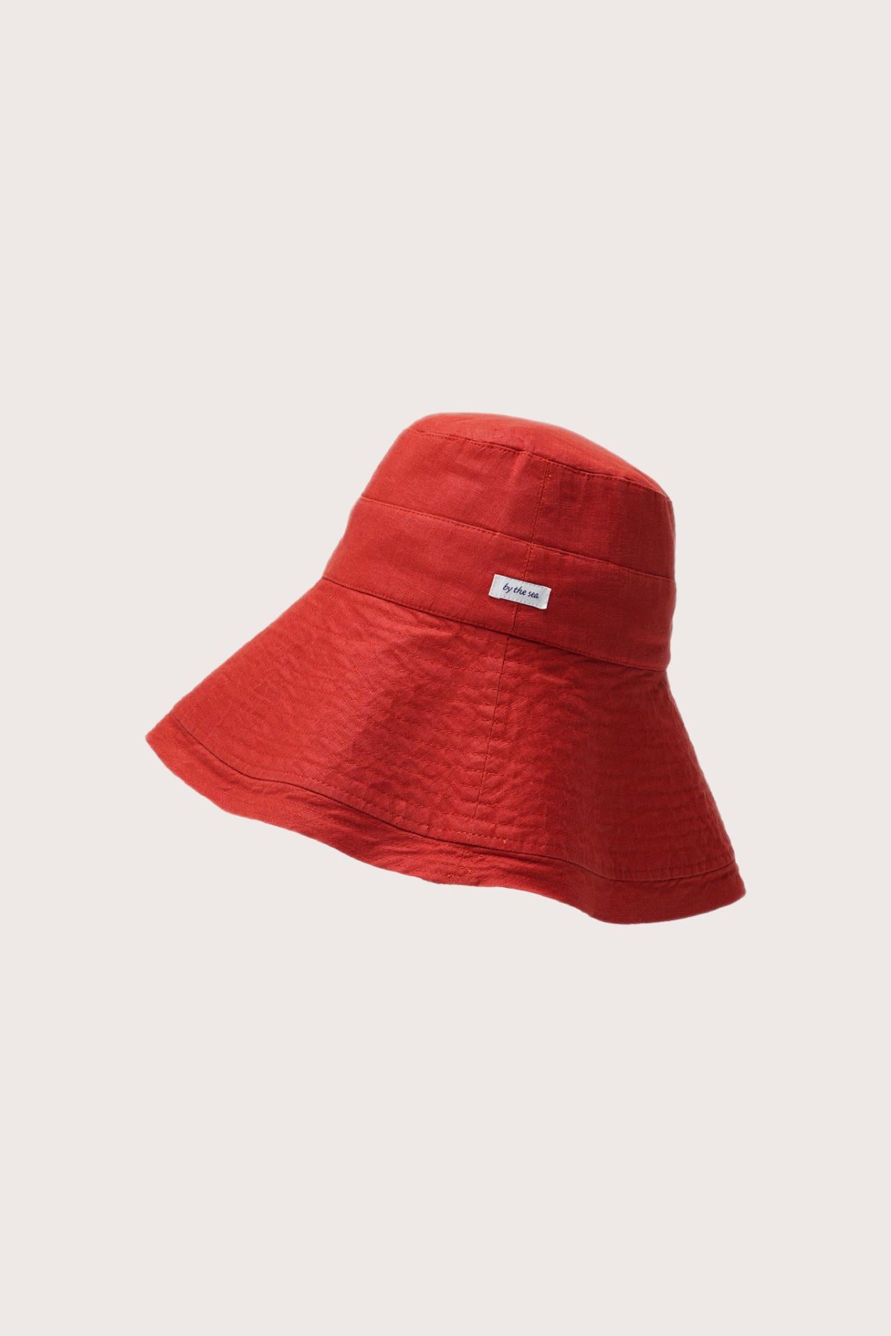 Side view of the Savanna Linen Hat Red highlighting its soft linen structure and graceful brim