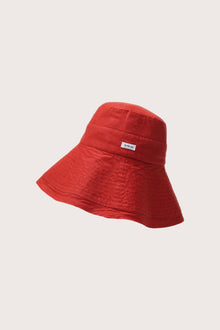 Side view of the Savanna Linen Hat Red highlighting its soft linen structure and graceful brim