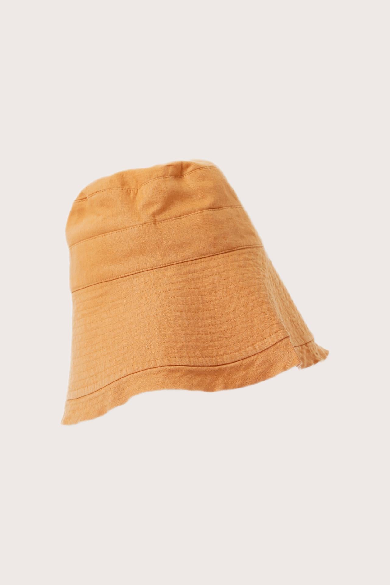 Side view of the Savanna Linen Hat Yellow highlighting its soft linen structure and graceful brim