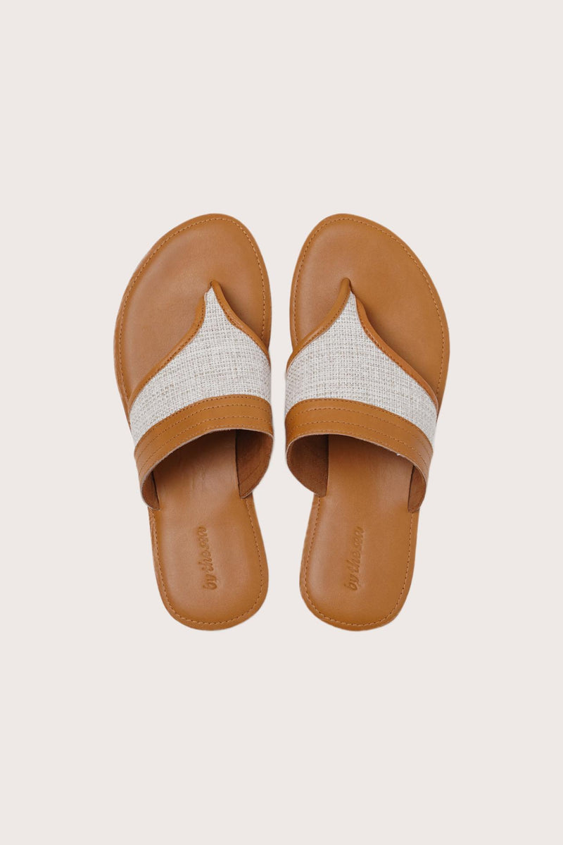 Savanna sandals in brown shown in a global view highlighting their full silhouette and refined resort design