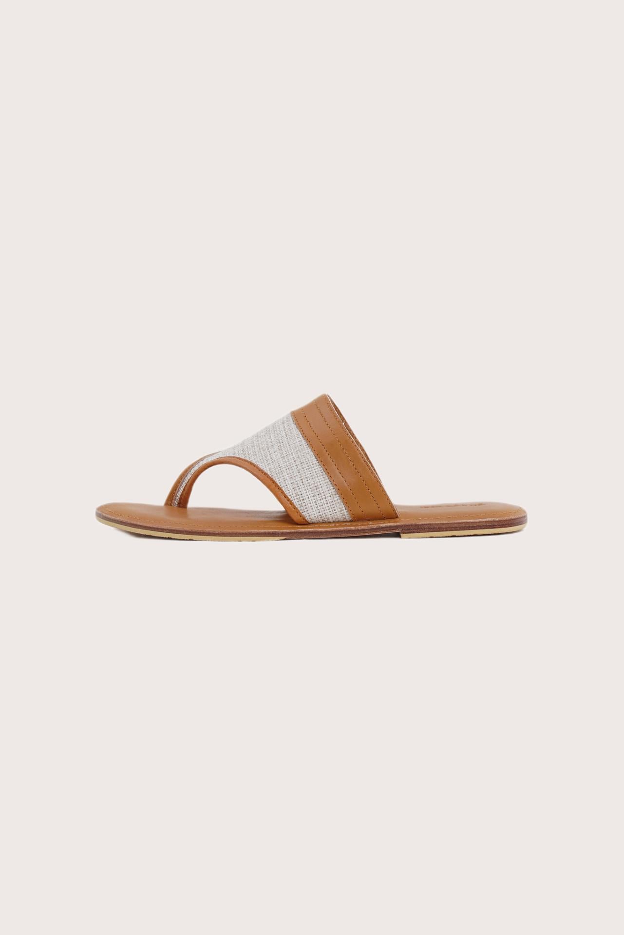 Side profile of Savanna sandals in brown highlighting sleek and modern resort footwear silhouette