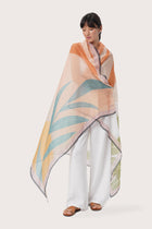 By The Sea Bali Savaya Sarong in Monstera Palm Cream featuring a tropical botanical print, worn as an elegant wrap silhouette