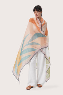 By The Sea Bali Savaya Sarong in Monstera Palm Cream featuring a tropical botanical print, worn as an elegant wrap silhouette