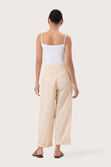 Back view of the Sawangan Cotton Pants Cream highlighting the garment shape and drape.