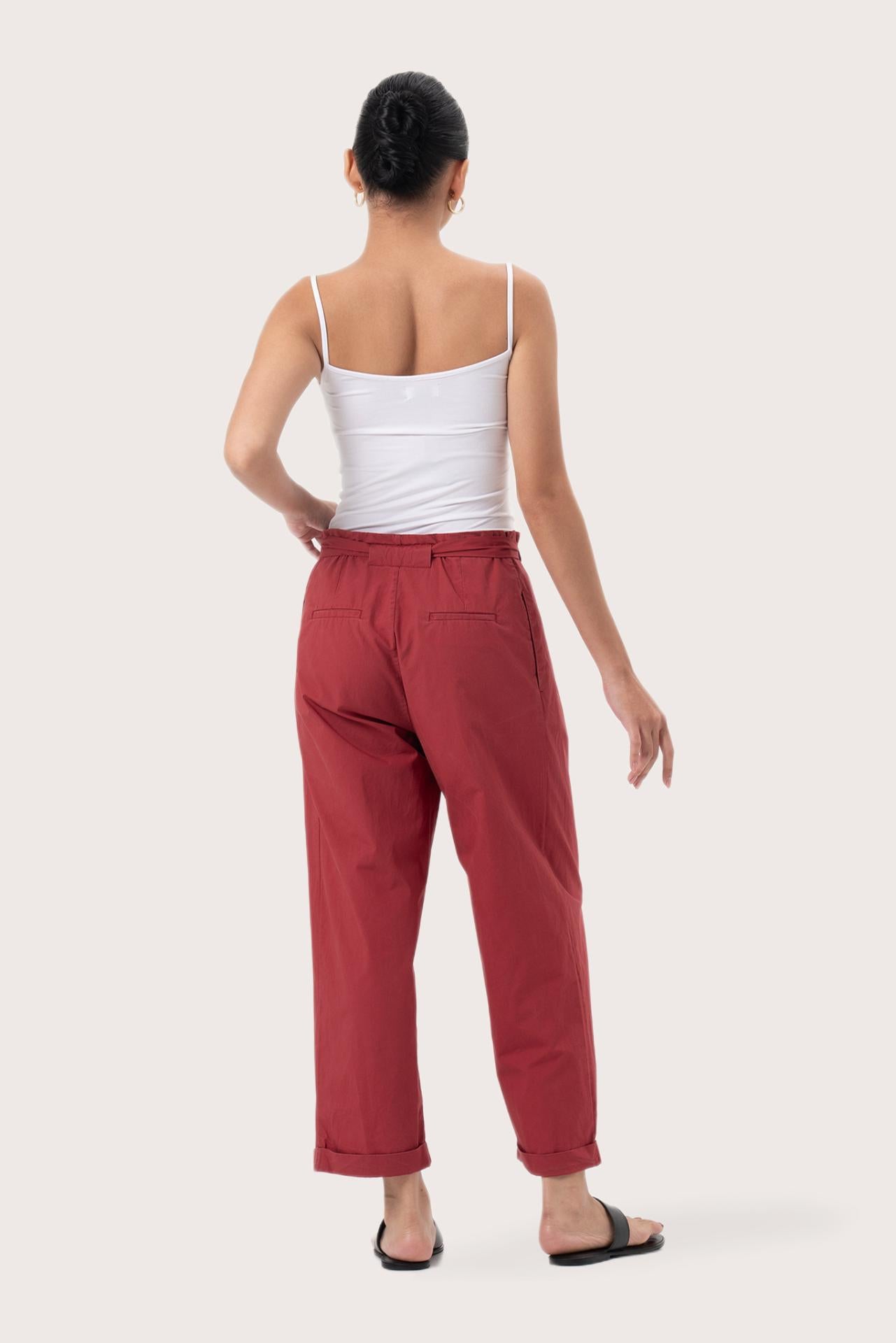 Back view of the Sawangan Cotton Pants Maroon highlighting the garment shape and drape.