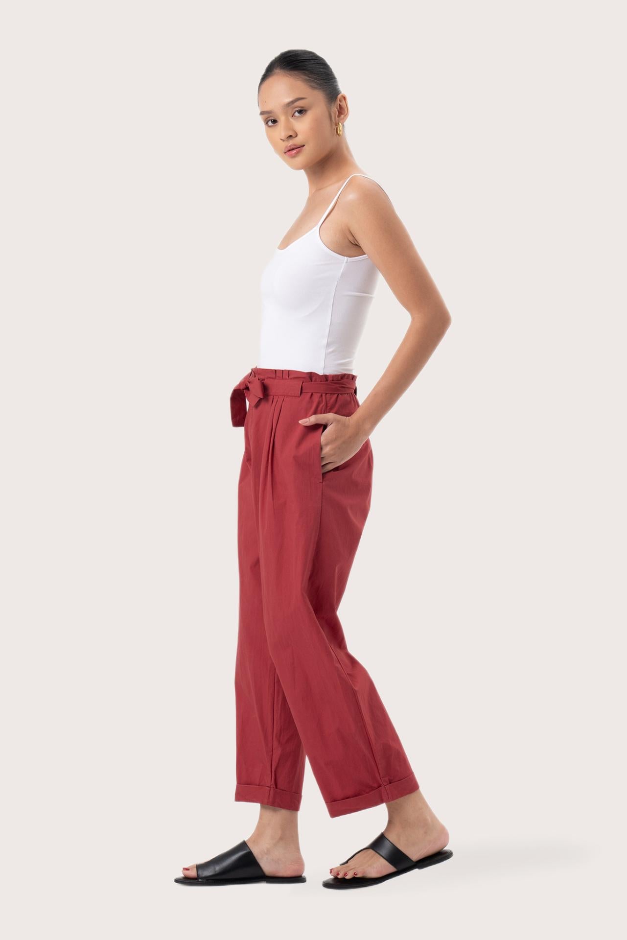 Side profile of the Sawangan Cotton Pants Maroon showing its cut and natural movement.