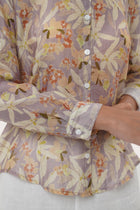 Close-up of the Selva Shirt Crisante Multicolor Cream Base sleeve showing relaxed structure and soft natural fabric finish and the hem highlighting clean stitching and durable garment finishing