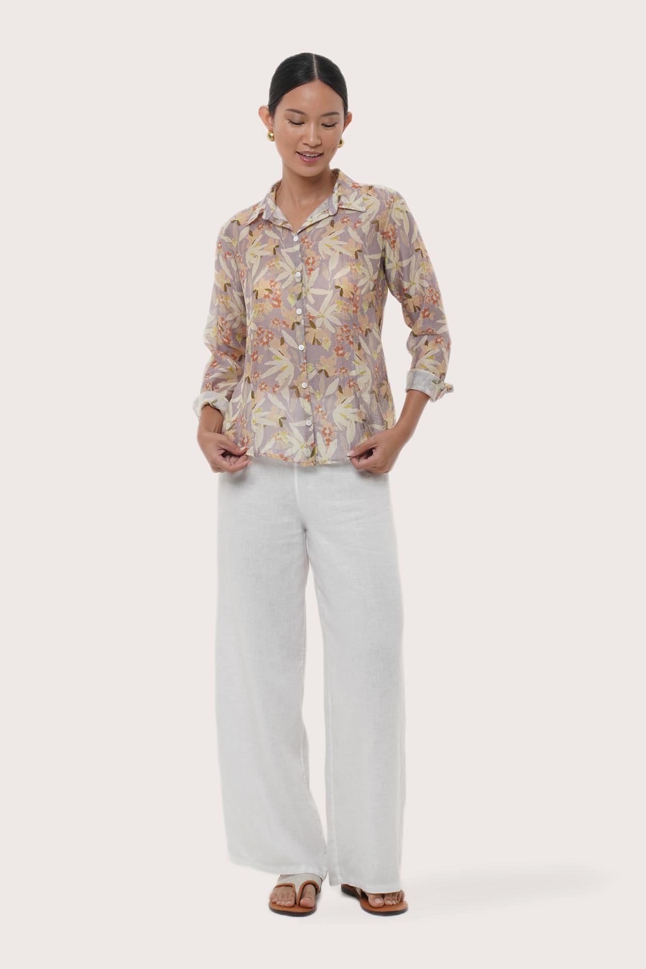 Woman wearing the Selva Shirt Crisante Multicolor Cream Base designed for effortless resortwear and tropical living by By The Sea Bali.