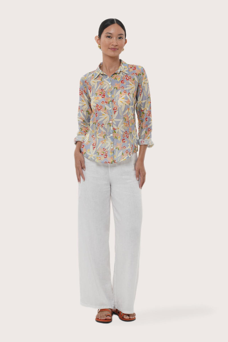 Woman wearing the Selva Shirt Crisante Multicolor Light Blue Base designed for effortless resortwear and tropical living by By The Sea Bali.
