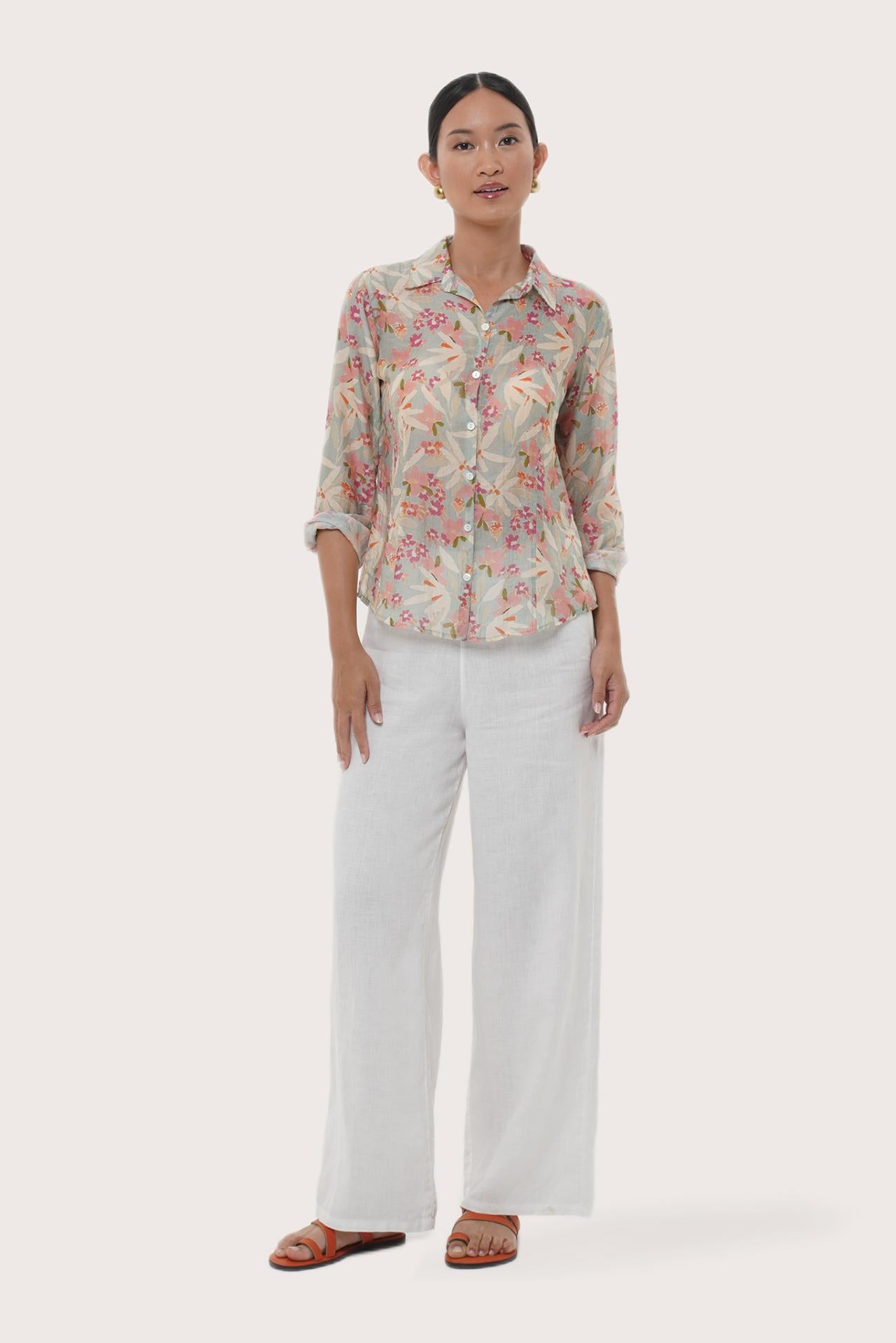 Woman wearing the Selva Shirt Crisante Multicolor Pastel Green Base designed for effortless resortwear and tropical living by By The Sea Bali.