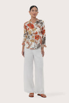 Woman wearing the Selva Shirt Raya designed for effortless resortwear and tropical living by By The Sea Bali.