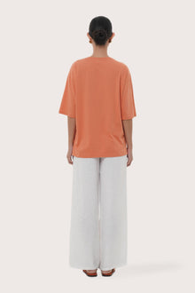 By The Sea Bali Back view of the Serva Loose T-Shirt in Orange Brick