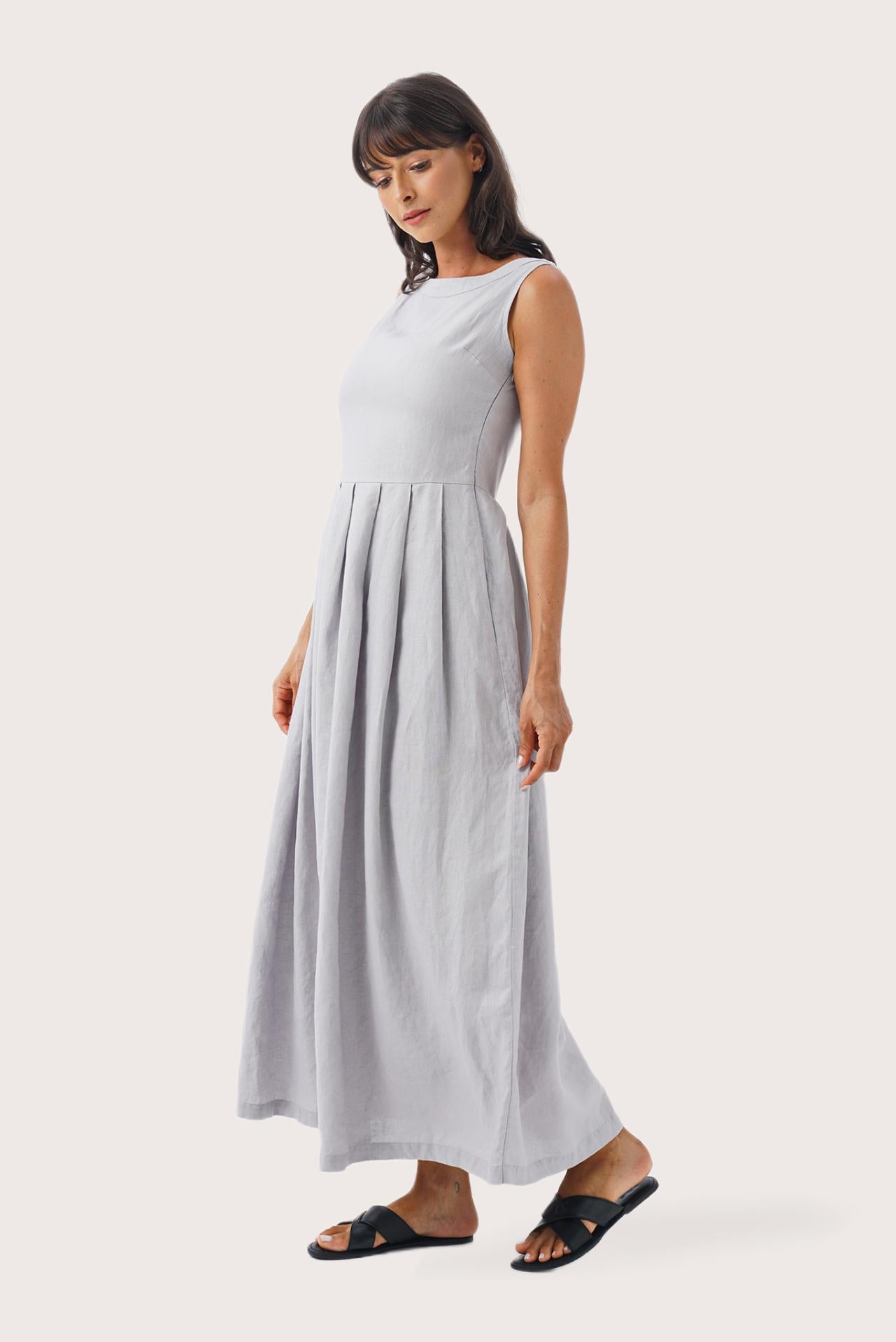Side profile of the Shino Maxi Dress Light Grey showing its cut and natural movement