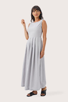 Woman wearing the Shino Maxi Dress Light Grey designed for effortless resortwear and tropical living by By The Sea Bali