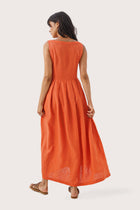 Back view of the Shino Maxi Dress Orange highlighting the garment shape and drape