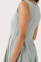 Close up detail of the Shino Maxi Dress Sage highlighting craftsmanship and design features