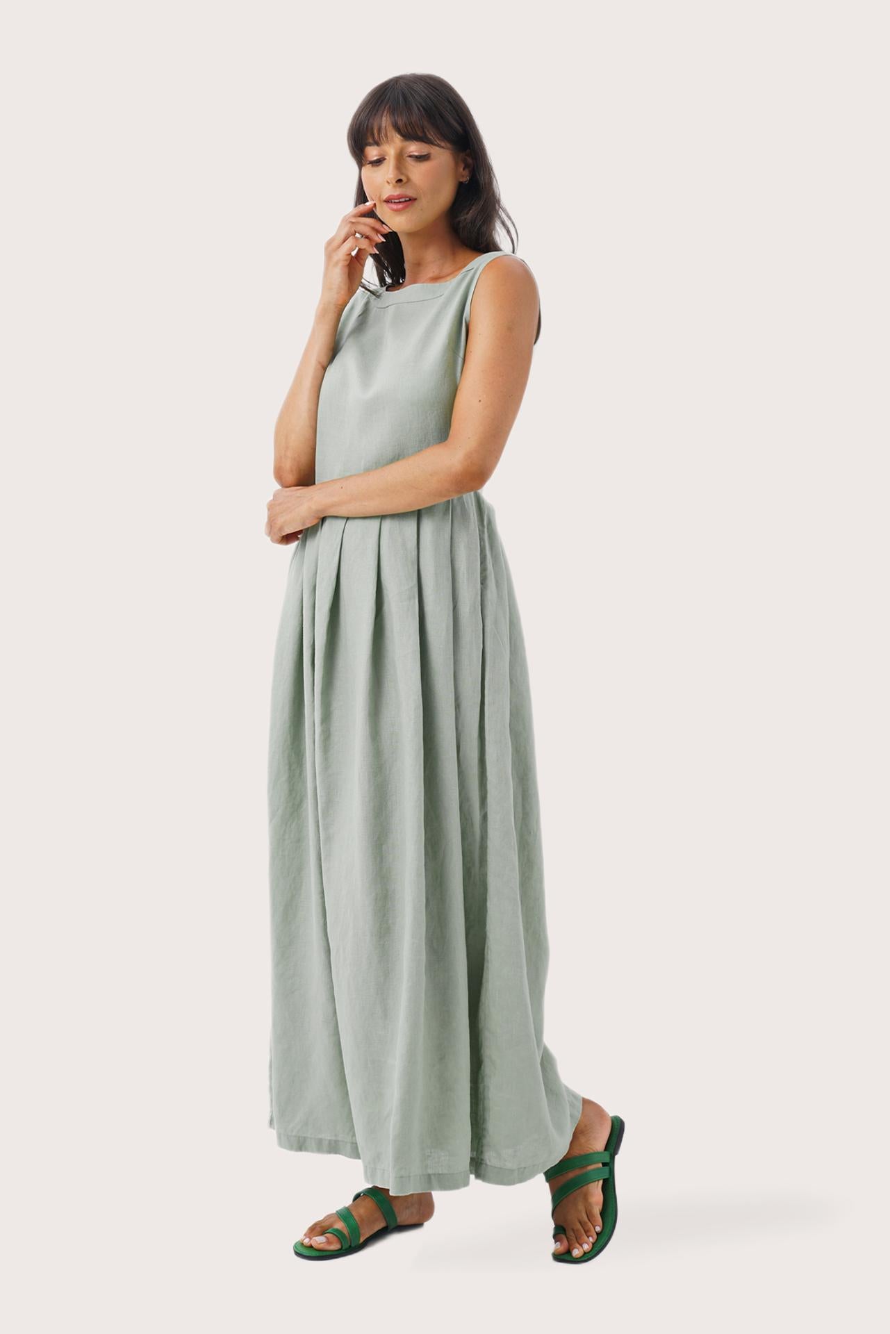 Side profile of the Shino Maxi Dress Sage showing its cut and natural movement