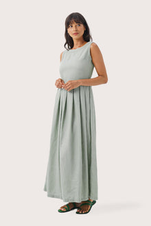 Woman wearing the Shino Maxi Dress Sage designed for effortless resortwear and tropical living by By The Sea Bali