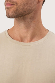 Close-up of the Skala T-Shirt Beige by By The Sea Bali – exceptional fabric quality and texture