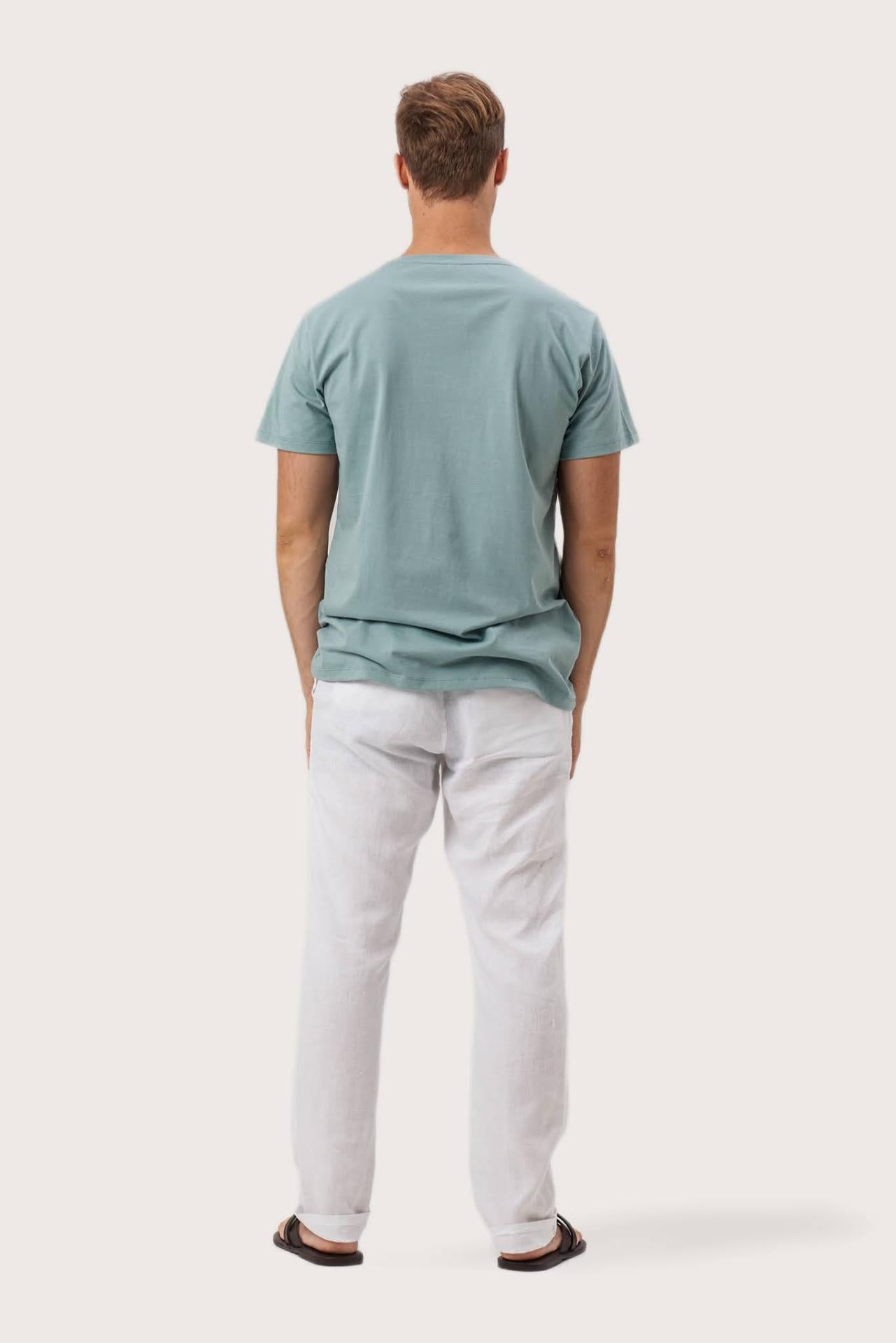 Back view of the By The Sea Bali Skala T-Shirt Sage – clean tailoring and refined craftsmanship