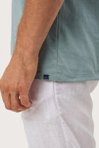 Angled detail of the Skala T-Shirt Sage by By The Sea Bali – refined craftsmanship up close