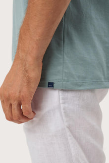 Angled detail of the Skala T-Shirt Sage by By The Sea Bali – refined craftsmanship up close