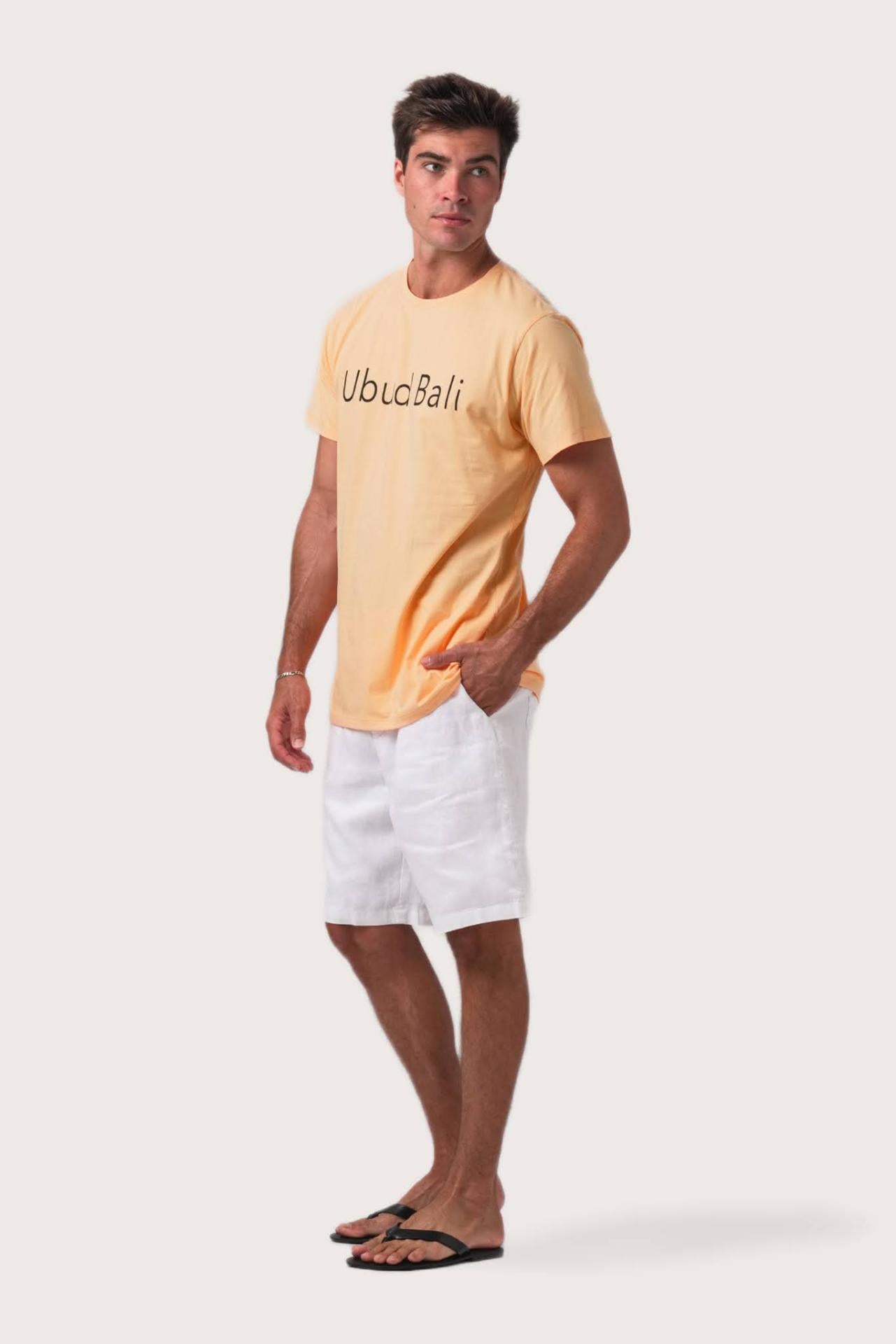 Side profile of the Skala Ubud t-shirt Peach by By The Sea Bali – relaxed drape and understated island elegance