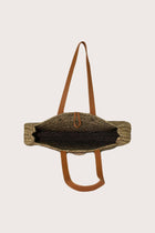Interior view of straw round bag showcasing spacious lined compartment and refined finishing