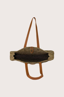 Interior view of straw round bag showcasing spacious lined compartment and refined finishing