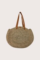 Back view of handcrafted straw round bag with circular silhouette and natural weave texture