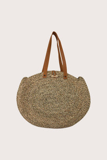 Back view of handcrafted straw round bag with circular silhouette and natural weave texture