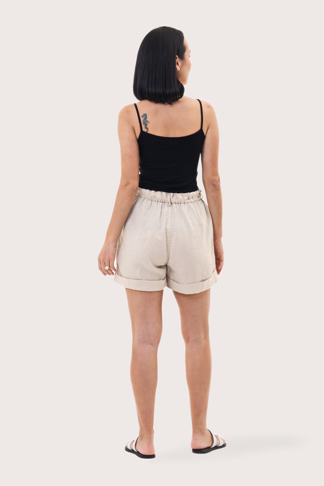 Back view of the Taloo Linen Bermuda Creme highlighting the garment shape and drape
