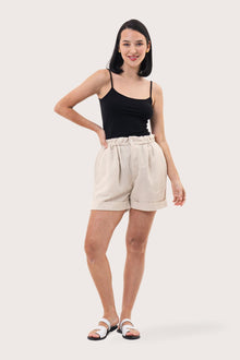 Woman wearing the Taloo Linen Bermuda Creme designed for effortless resortwear and tropical living by By The Sea Bali