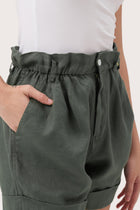 Close up detail of the Taloo Linen Bermuda Foglie Dark Green  highlighting craftsmanship and design features