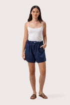 Woman wearing the Taloo Linen Bermuda La Brisa Navy designed for effortless resortwear and tropical living by By The Sea Bali