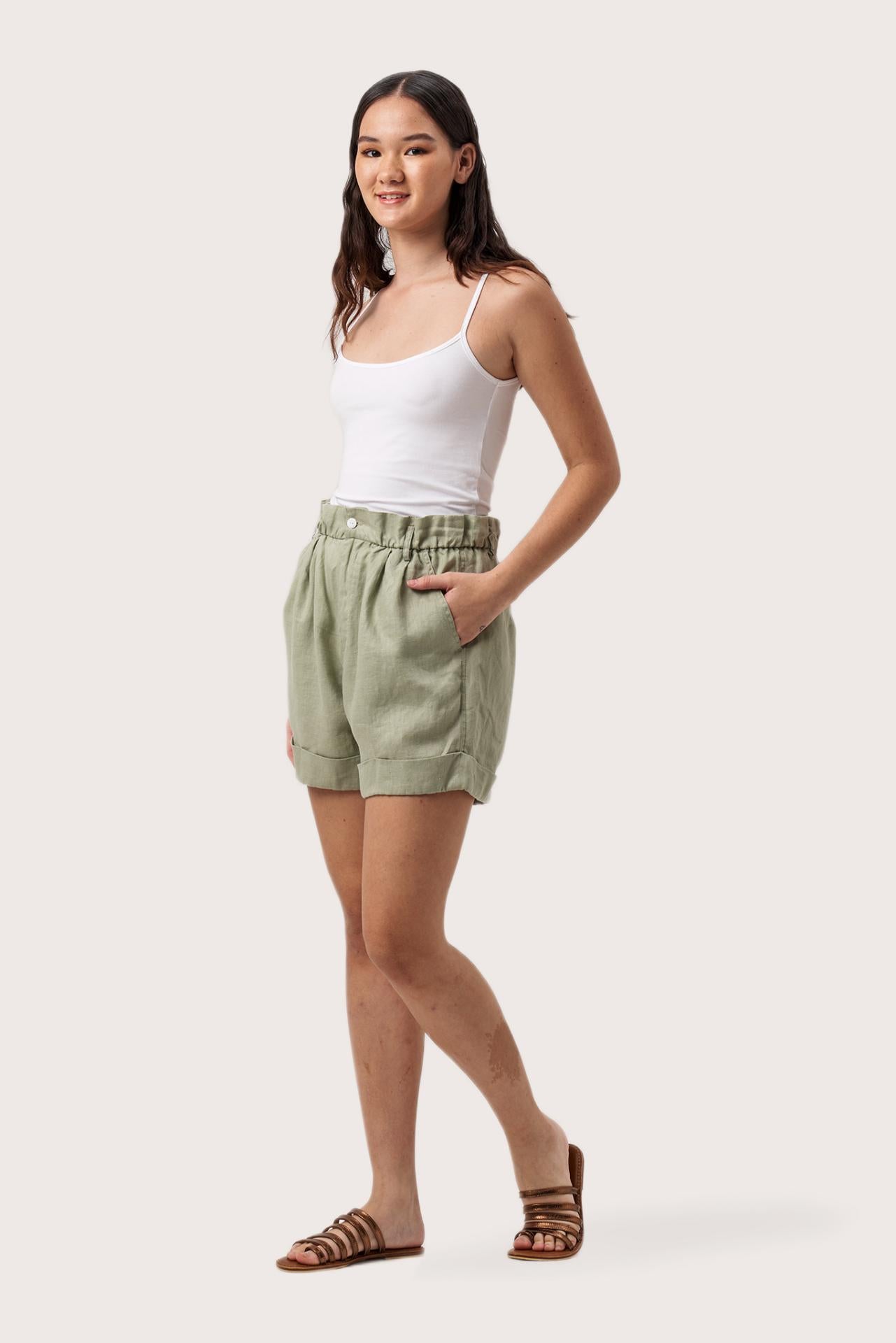 Side profile of the Taloo Linen Bermuda Sage showing its cut and natural movement