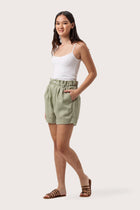 Side profile of the Taloo Linen Bermuda Sage showing its cut and natural movement