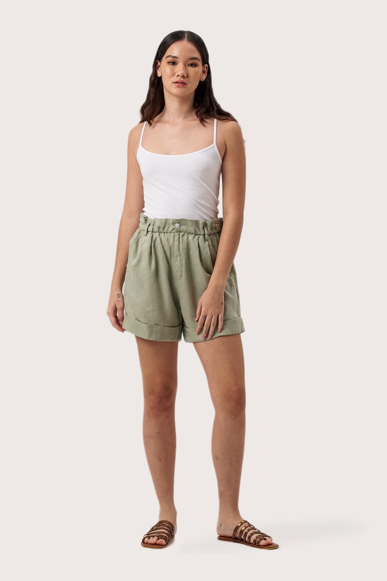 Woman wearing the Taloo Linen Bermuda Sage designed for effortless resortwear and tropical living by By The Sea Bali