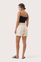 Back view of the Taloo Linen Bermuda Crema highlighting the garment shape and drape