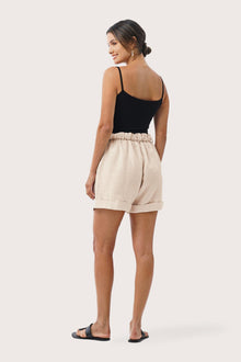 Back view of the Taloo Linen Bermuda Crema highlighting the garment shape and drape